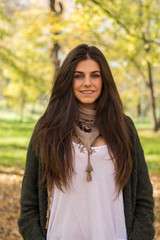 Fototapeta premium White girl with blue eyes posing in the forest in autumn.