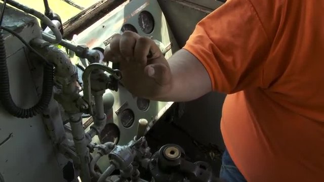 Engineer sounds the horn in diesel locomotive cab while driving a train in the Mid West, USA.  Detail shot.
