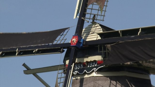 Dutch Windmill in operation - close up windshaft, beard + cap. The Vilsteren windmill dates from 1858. It has been used for milling grain for more than 100 years.