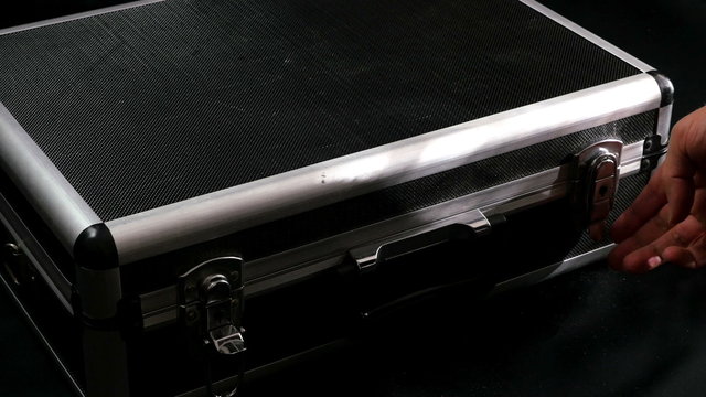 Man opens a case with photo equipment
