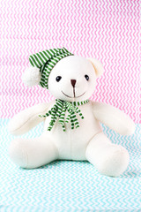 bear doll sit on fabric color of pastel