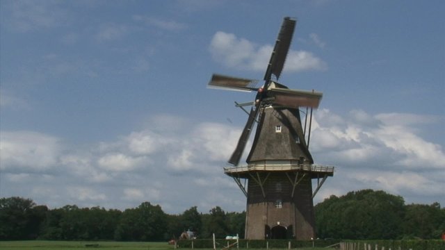 Dutch Windmill in operation in rural landscape. The Vilsteren windmill dates from 1858. It has been used for milling grain for more than 100 years.