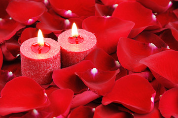 red candles and rose petals background