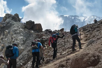 Gardinen Hiking group of people climb to crater of active volcano © Alexander Piragis