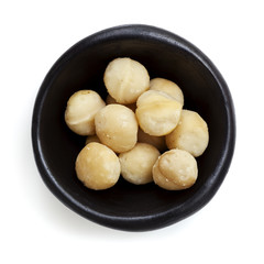 Macadamia Nuts in Black Bowl Overhead View Isolated on White