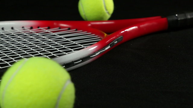 tennis racket with three tennis balls
