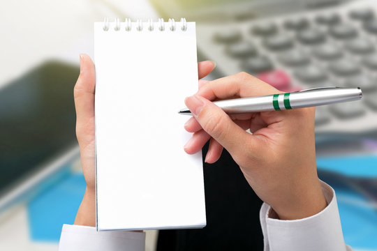 Businessman hand writing a note in blank.