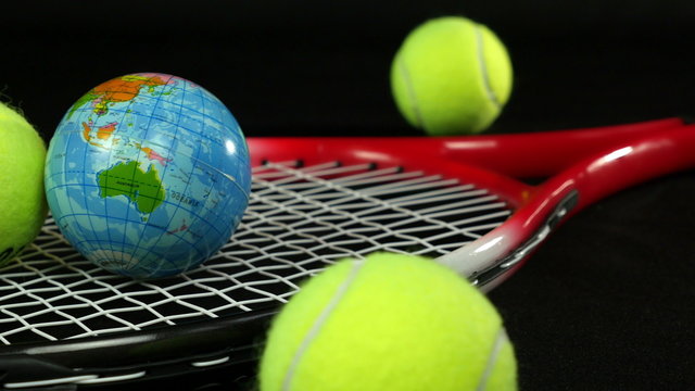 tennis racket with three tennis balls and one ball the globe