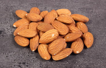 Heap of almonds on concrete structure