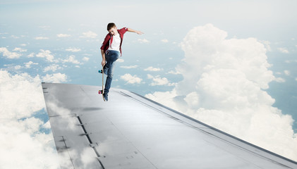 Boy riding skateboard on wing