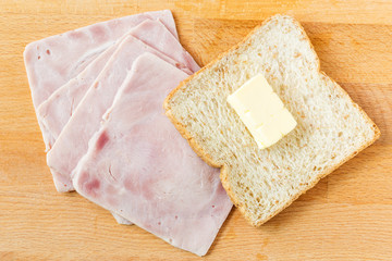 Ham,cheese  and bread on a wooden cutting board