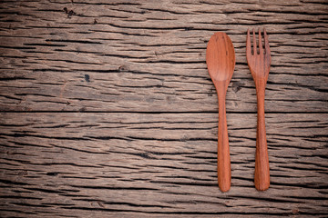 Fork and spoon on grunge wood food background concept ,menu desi