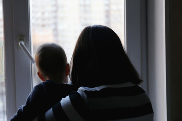 Mom with a child looking out the window