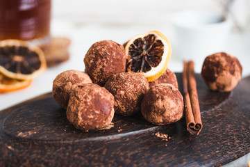 Raw chocolate candy with nuts, figs and citrus, truffle