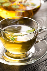 Cup with flower tea and teapot