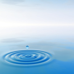 Conceptual blue liquid drop falling in water