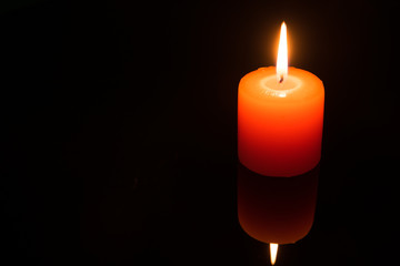 Light a candle on black background