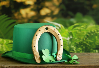 traditional symbols for Patrick's Day - green hat, horseshoe and clover