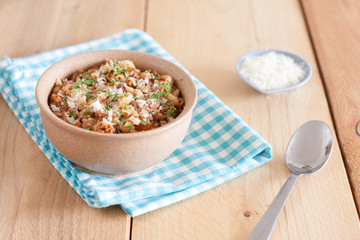 A bowl of macaroni with ground beef, tomatoes and parmesan
