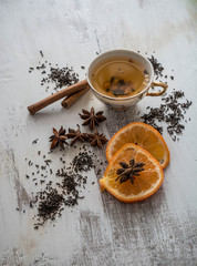 Obraz na płótnie Canvas Tea, dried cinnamon,orange and anise on wooden background