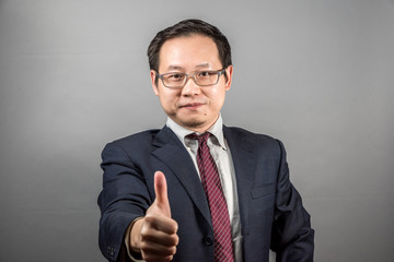 Confident Chinese Businessman Posing a YES sign