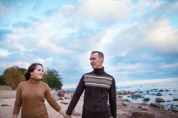 young couple walking on the rocky beach