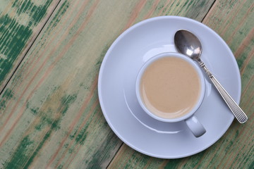Coffee Cup on Green Wooden Table