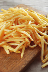 French fried potatoes on cutting board