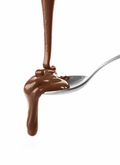 Melted milky brown chocolate pouring from a spoon, isolated on white