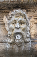 Fototapeta na wymiar Mask decoration on a fountain in Rome Italy
