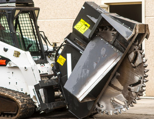 wreath with cones for drilling rock mounted on mini excavator'