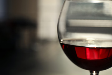Glass of red wine on blurred background