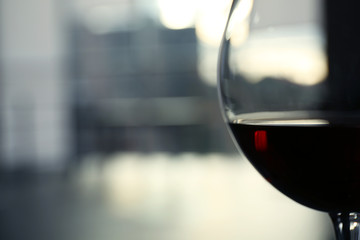 Glass of red wine on blurred background