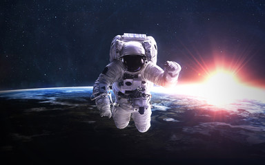 Fototapeta na wymiar Astronaut in outer space against the backdrop of the planet earth. Elements of this image furnished by NASA.