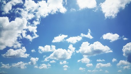 Blue clear sky with fluffy clouds, beautiful summer day