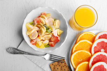 Fruit salad on wooden background. Healthy eating concept.