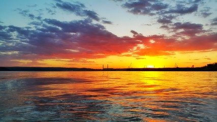 Scenic sunset over the lake and the sea port
