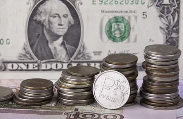 coin ruble on background of dollar banknote and money stacks