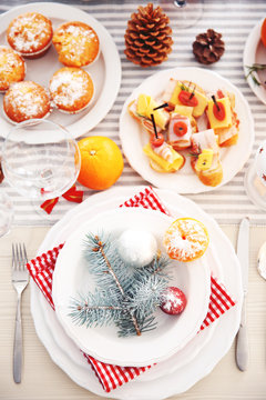 White plates with flatware on a Christmas table