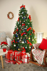 Christmas fir tree with gifts in living room