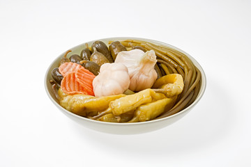 The pickled vegetables on the plate. Shot on a light background.