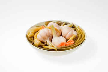 The pickled vegetables on the plate. Shot on a light background.