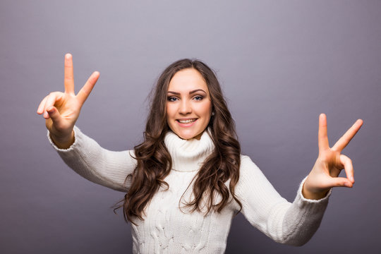 happy people concept - young woman showing victory or peace sign