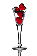 red glass hearts in the bowl on white background