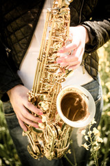 Fototapeta premium Woman playing saxophone i- detail