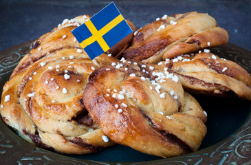 Traditional Swedish cinnamon buns served on a rustic plate. A very popular snack throughout...