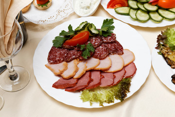 Meats, salami, carbonate on white dish