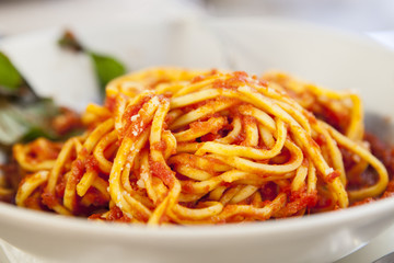 Plate of spaghetti bolognese with basil garnish