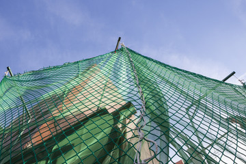 Hanging protection net on building construction site