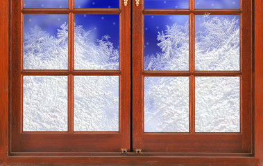 window with frost and night snow nature background